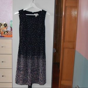 A short blue dotted dress with a tie back